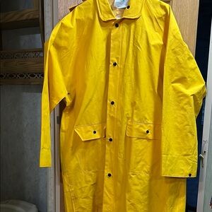 Boss manufacturing raincoat with adjustable strap bibs. Yellow, removable hood.